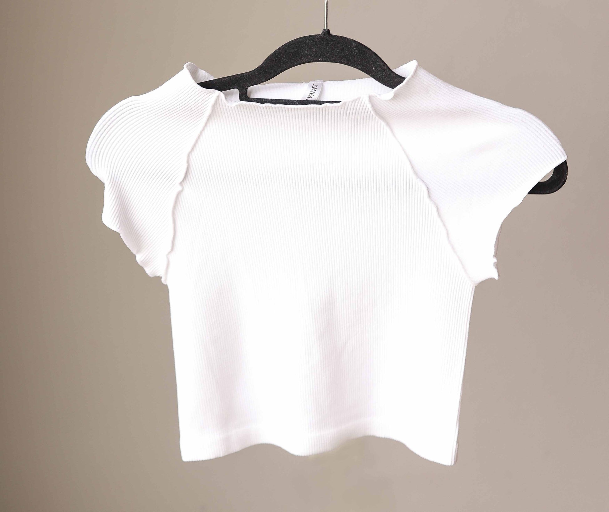This White Ribbed Short Sleeve Half Tee is designed for comfort and style. Its ribbed, stretchy fabric offers a snug, fitted look that layers effortlessly without adding bulk. Perfect for nursing moms too!