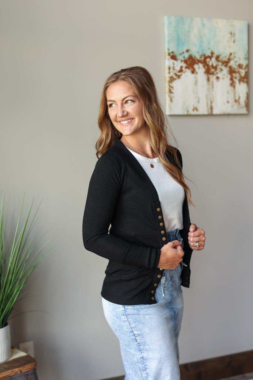 Hot pink snap cardigan styled on a model, perfect for a versatile and affordable summer sweater cardigan at Classy Closet, an online modest women's boutique.