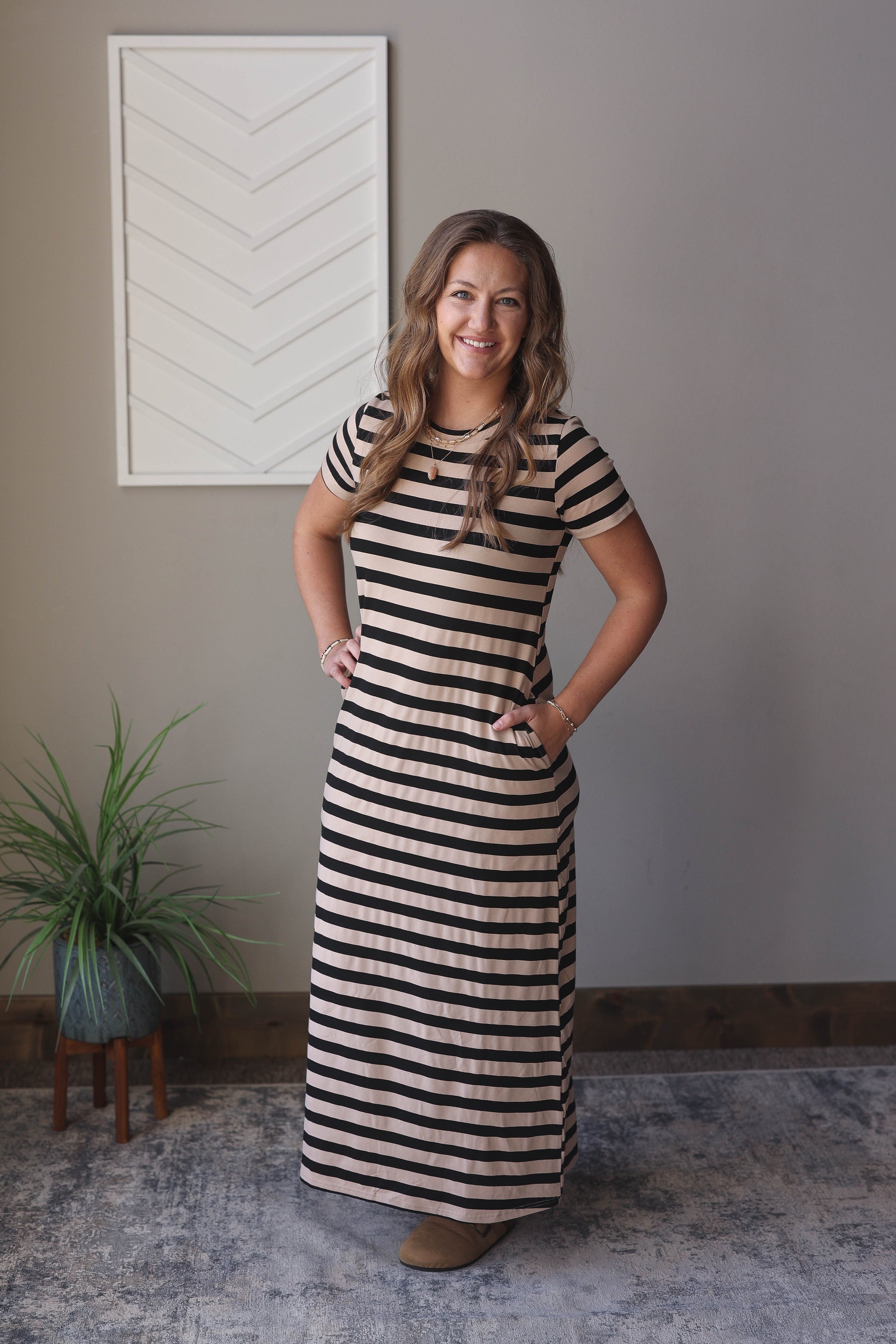 Bring simplicity and joy to your summer wardrobe with our Black Stripe Crewneck Maxi Dress. This must-have dress features convenient pockets, short sleeves, and a versatile crew neck for everyday style. Perfect for any occasion, you'll love the comfortable and stylish look. Classy Closet online women's boutique for modest fashion, denim skirts, and affordable trendy tops. Hull, Iowa