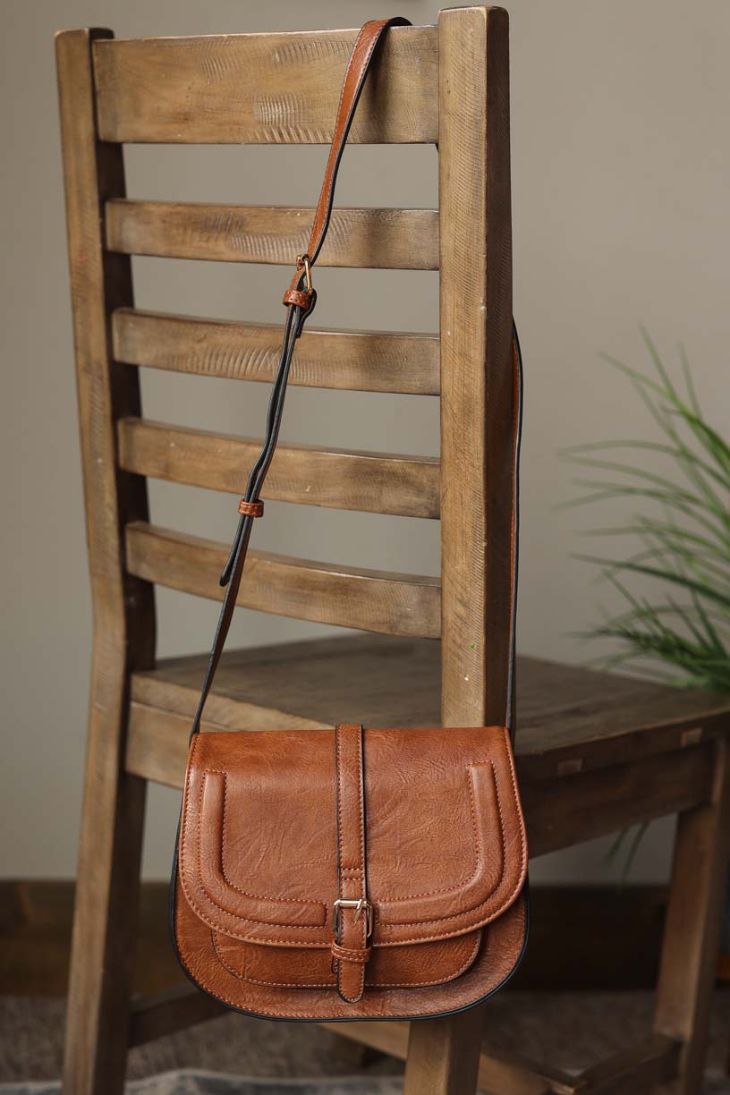 Say "Hello" to our Chestnut Flap Magnetic Buckle Shoulder Bag - the perfect combination of dressy and chic. With its sturdy shape and convenient magnetic snap closer, this bag is perfect for any occasion - from work to date night to events. Plus, the adjustable shoulder strap makes it comfortable to carry all day long. Classy Closet online boutique women's accessories for modest trendy affordable fashion