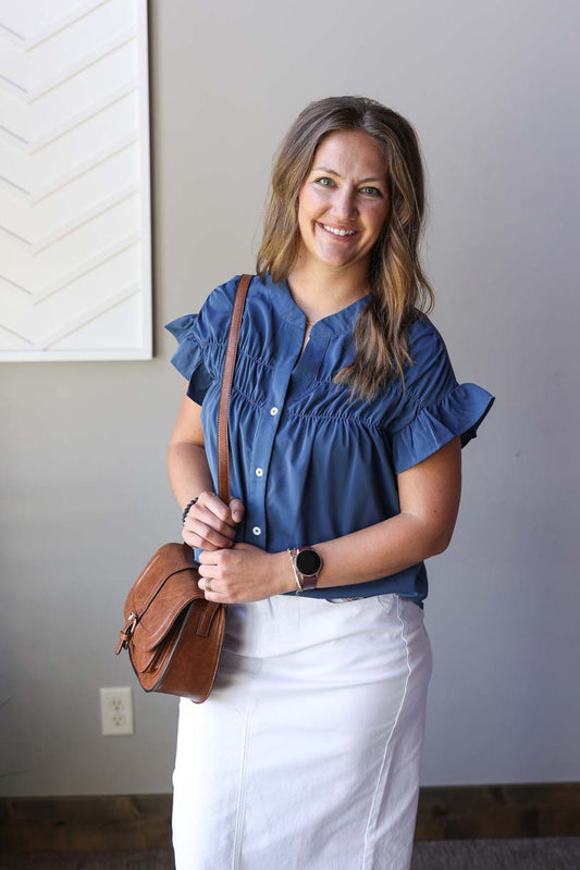 Elevate your style with this adorable teal button-up blouse! Perfect for date nights, weddings, or office wear, this lightweight top features ruched details and ruffle short sleeves. The rich dark blue-teal color adds a nautical touch while keeping your look polished and versatile. Dress it up or down for different occasions!