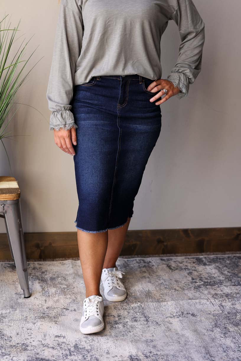 Becca Dark Wash Side Slit Denim Skirt. This stylish jean skirt features a dark wash for a sleek and sophisticated look that you can wear to work, school, or date night for fall winter outfits.