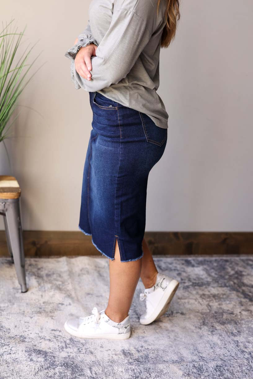 Becca Dark Wash Side Slit Denim Skirt. This stylish jean skirt features a dark wash for a sleek and sophisticated look that you can wear to work, school, or date night for fall winter outfits.