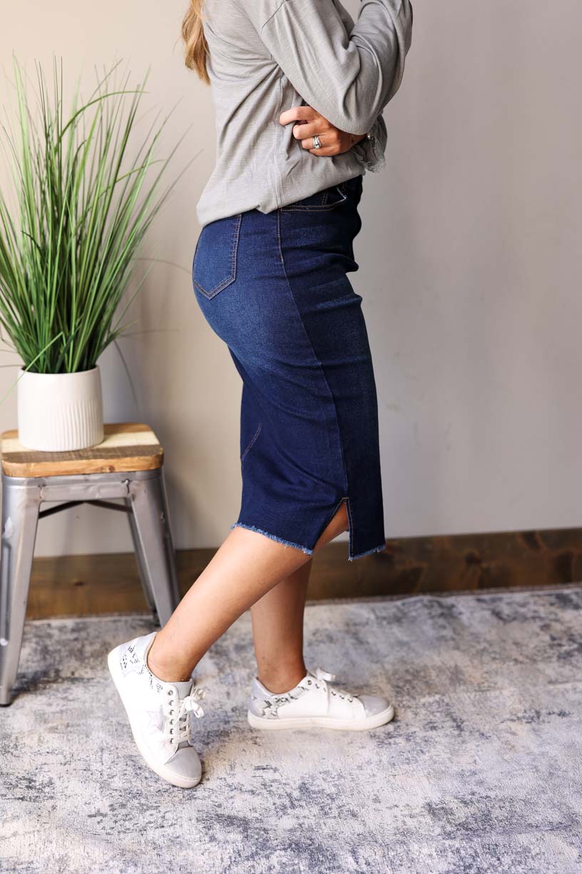 Becca Dark Wash Side Slit Denim Skirt. This stylish jean skirt features a dark wash for a sleek and sophisticated look that you can wear to work, school, or date night for fall winter outfits.