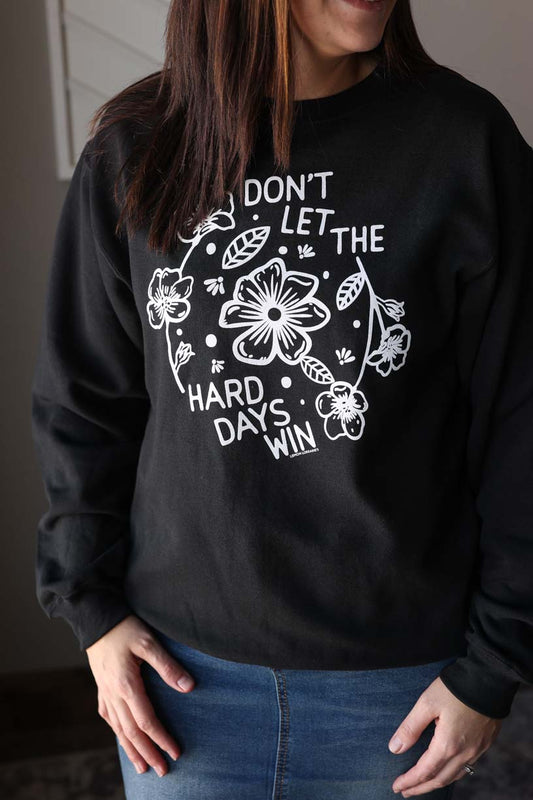 Conquer the toughest days with our "Don't Let the Hard Days Win" Crewneck Sweatshirt. Featuring a motivational graphic, this cozy sweatshirt will remind you that you've got this! Stay comfortable and empowered all day long. Classy Closet modest fashion for women's clothing and 2025 fashion trends. Hull Iowa