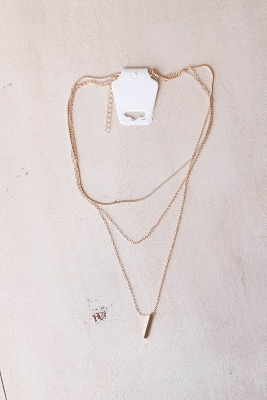 Add a touch of chic to any outfit with our Gold Bar Layered Necklace. Featuring a single gold bar and 3 layers, this cute and chic necklace is the perfect accessory for any fashion-loving mom. Feel confident in your style and make a statement with this layered necklace.