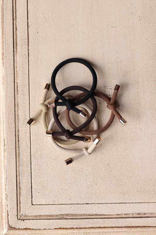 Elevate your hair game with our 5pc Camel Elastic Knotted Hair Ties! These trendy "bracelets" are not only functional but also add a fun accessory to your wrist. Perfect for a stylish look on the go, you or your girls will love the cute details. Get yours now! Classy Closet is a women's clothing boutique for everyday functional style and denim skirts.