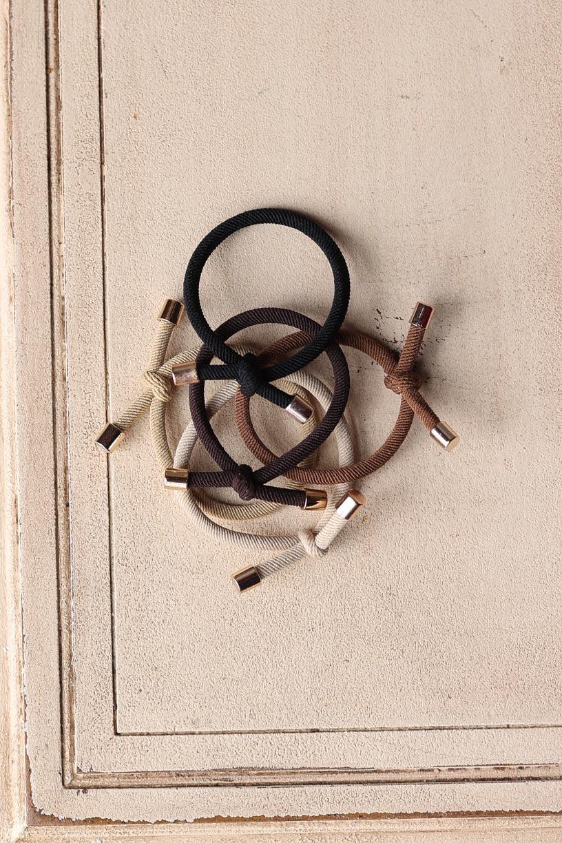 Elevate your hair game with our 5pc Camel Elastic Knotted Hair Ties! These trendy "bracelets" are not only functional but also add a fun accessory to your wrist. Perfect for a stylish look on the go, you or your girls will love the cute details. Get yours now! Classy Closet is a women's clothing boutique for everyday functional style and denim skirts.