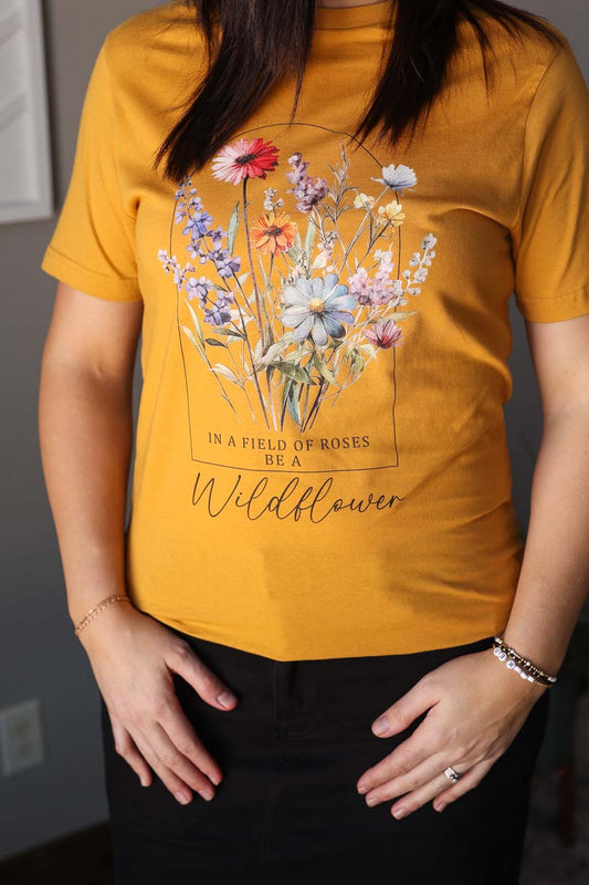 Be a wildflower in our Mustard Wildflower Tee! This fun graphic tee with the quote "in a field of roses, be a wildflower" is perfect for both solo wear and layering, allowing for versatile styling all season long. Embrace your unique style and embrace the happy and simple vibes with this must-have tee. Classy Closet online women's clothing boutique for modest fashion, cute mom outfits, everyday outfits.
