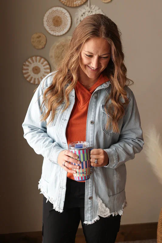 Modest chestnut orange hooded top with colorblock sleeves worn as an everyday outfit under a denim shirt