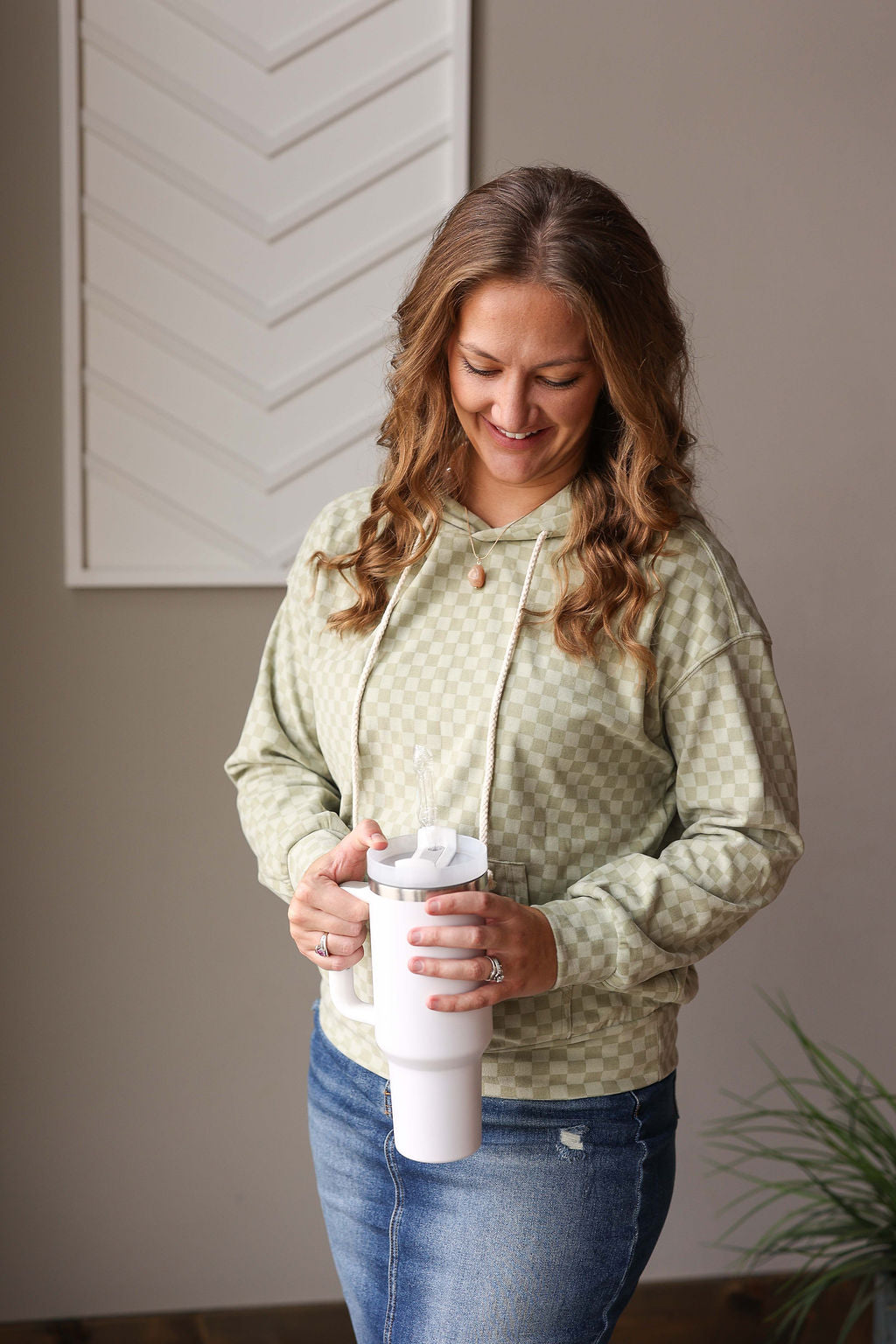 Stay stylish and comfortable with our Mint Checkered Kangaroo Pocket Hoodie! Made from a soft and light-medium weight material, this sweatshirt is perfect for any season. The subtle checkered design adds a touch of charm, making you feel cozy and chic at the same time. Get ready to be obsessed with this must-have piece! Classy Closet online women's clothing boutique for trendy, cute tops and modest fashion by Hull iowa.