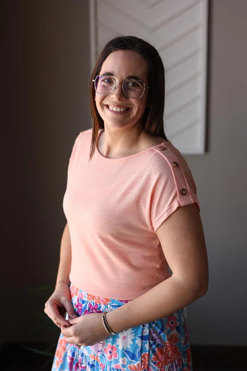 Stylish and effortless, our Coral Button Detail Tee is perfect for spring and summer. With its soft and lightweight material, you can comfortably wear it all day at work, home, or out with friends. Complete the look with our Blue Floral Wrap Maxi Skirt. Classy Closet Boutique Hull Iowa