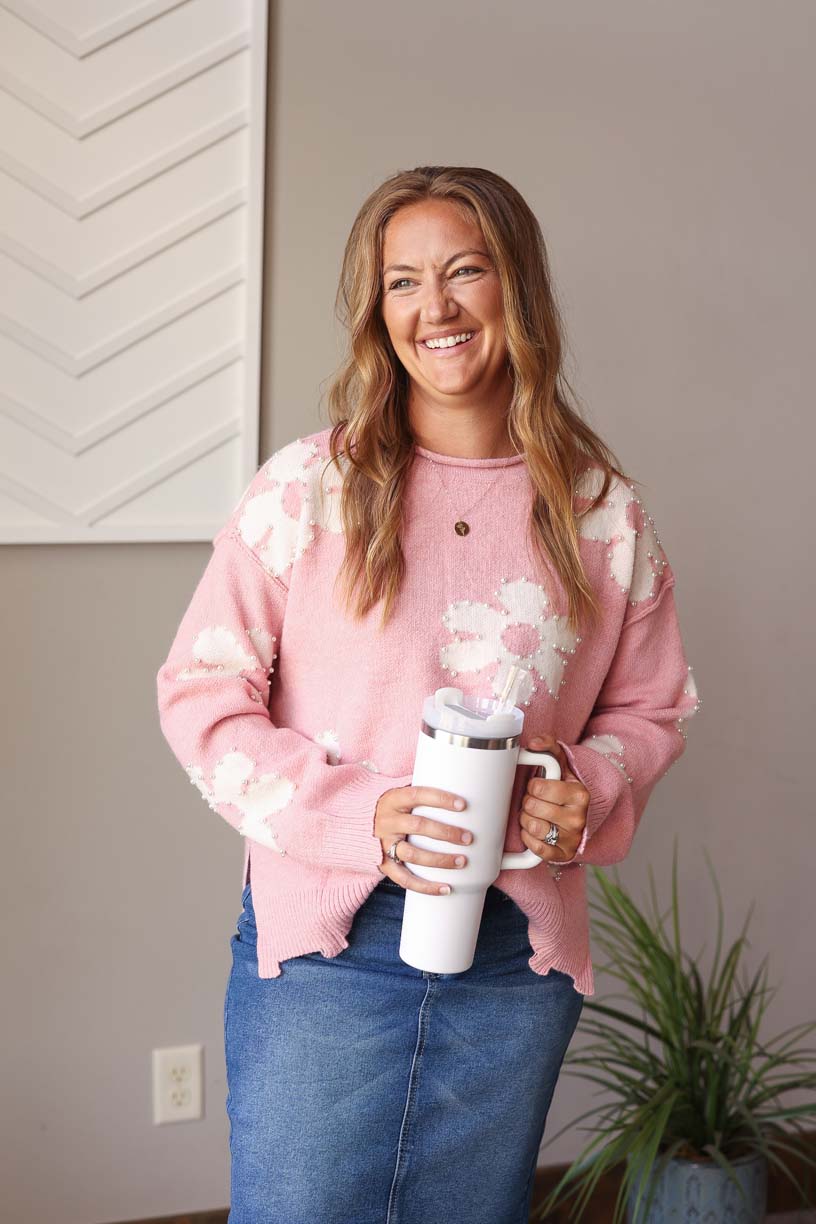 Stay cozy and stylish with our Pink Pearl Beaded Floral Sweater! This sweater features a trendy distressed hem and a delicate daisy print with elegant pearl accents. Its cozy material makes it perfect for both work and outings. For expecting moms, this sweater can even be styled over a black dress for a cute bump outfit. Classy Closet online women's clothing boutique for cute trendy mom styles and fall winter outfits 2024