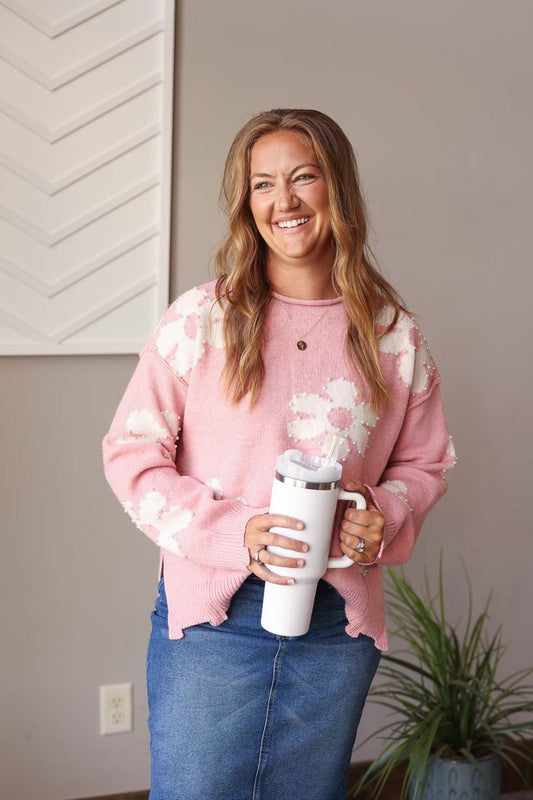 Stay cozy and stylish with our Pink Pearl Beaded Floral Sweater! This sweater features a trendy distressed hem and a delicate daisy print with elegant pearl accents. Its cozy material makes it perfect for both work and outings. For expecting moms, this sweater can even be styled over a black dress for a cute bump outfit. Classy Closet online women's clothing boutique for cute trendy mom styles and fall winter outfits 2024