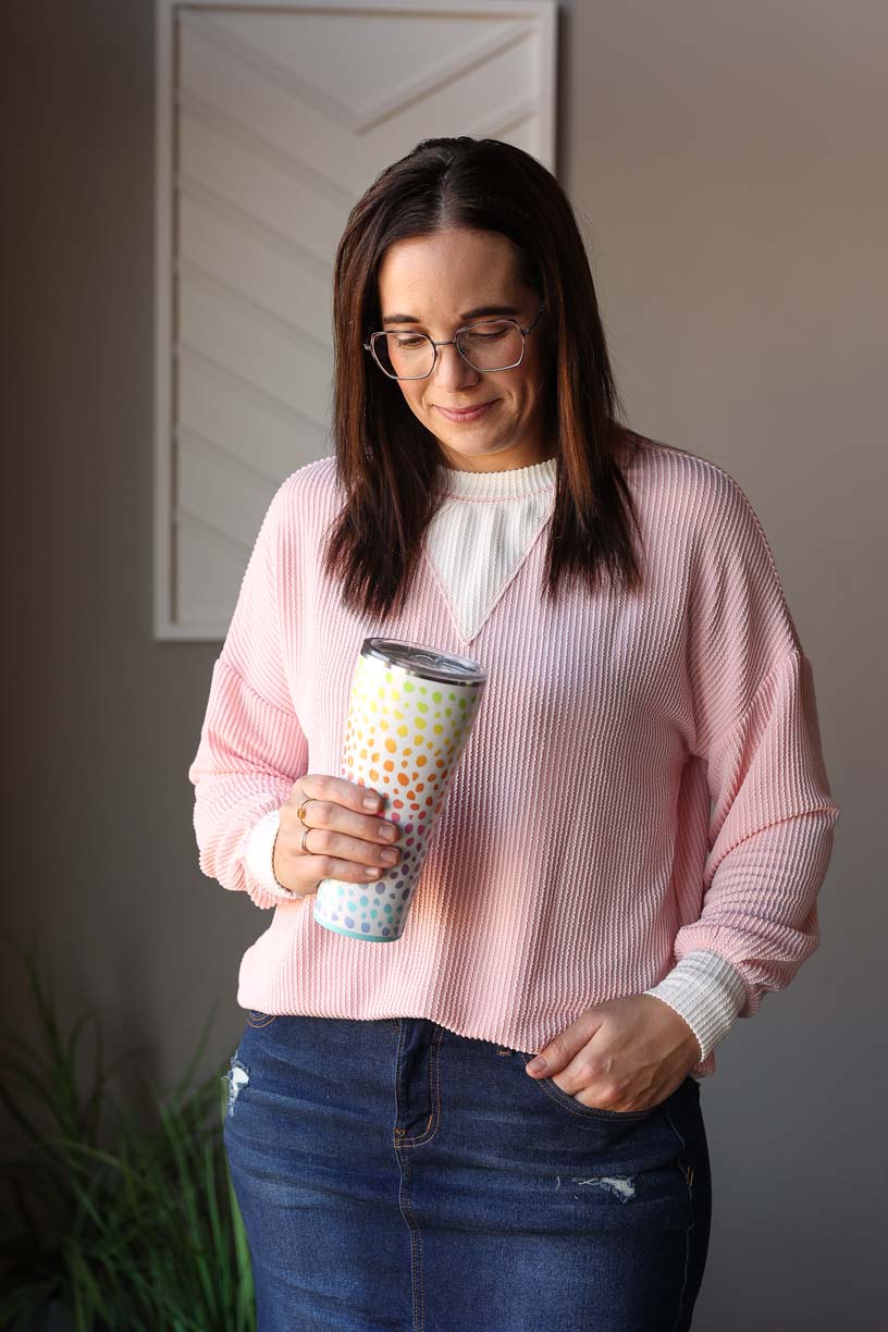Shop our Coral Pink Corded Colorblock Top, the perfect addition to your wardrobe. Made with the top favorite, corded fabric, this shirt features a calming, soft coral pink color with white insert details on the cuffs, hem, and neck. Long sleeves for everyday comfort while adding an energetic, feminine touch to your outfit. Available in sizes S-2XL PLUS, as it can be worn true to size or sized down. Classy Closet online women's clothing boutique for modest trendy and cute mom outfits. Spring Summer 2025