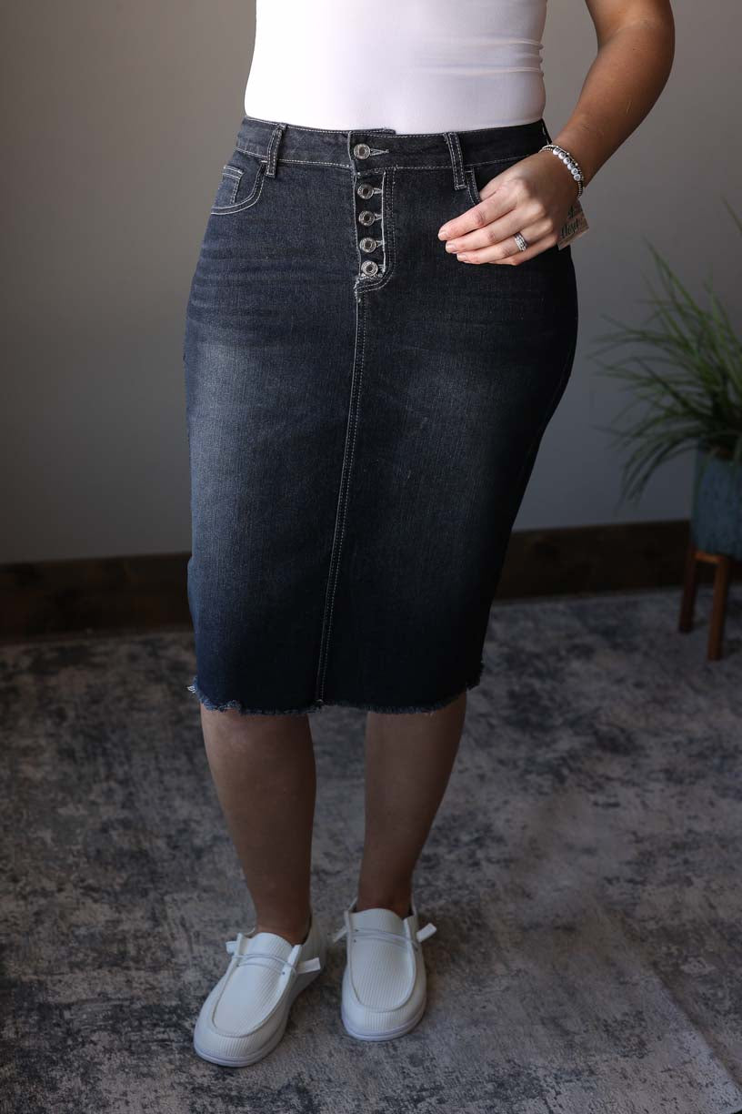 Elevate your wardrobe with our Fray Button Fly Midi Black Denim Skirt. Designed for effortless, stylish and modest outfits, this skirt is made with stretchy denim for amazing comfort. The unique 5 button fly detail adds a touch of chic to any look. Classy Closet Hull Iowa for women's hard to find denim skirts, Knee length midi skirts for modest women skirts