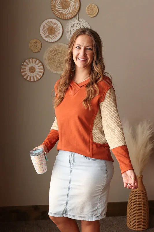 Colorblock sleeve v-neck hooded top in chestnut orange styled for a modest outfit paired with light wash denim skirt knee length for modest fashion
