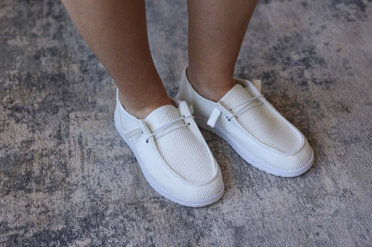 Introducing your new go-to White Ribbed Slip On Shoes! These shoes are perfect for everyday wear, providing comfort and trendy cuteness to any outfit. Slip them on and feel happy and confident all day long! Classy Closet online women's boutique for trendy, affordable fashion tops, denim skirts, and shoes. everyday chic styles for moms, teachers, office, in Hull iowa
