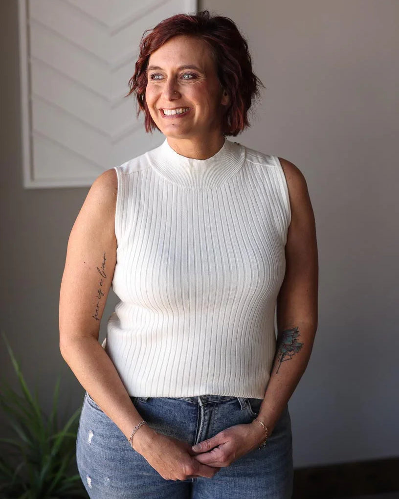 Stay stylish all year round with our White Ribbed Mockneck Sleeveless Sweater! Made from a lightweight, soft sweater material, this versatile piece features a slight mock neck and chic shoulder accents. Keep cool in the summer or layer up for colder days. A must-have classic in your wardrobe! Classy Closet online women's boutique clothing for affordable womens tops and hard to find modest denim skirts. hull iowa