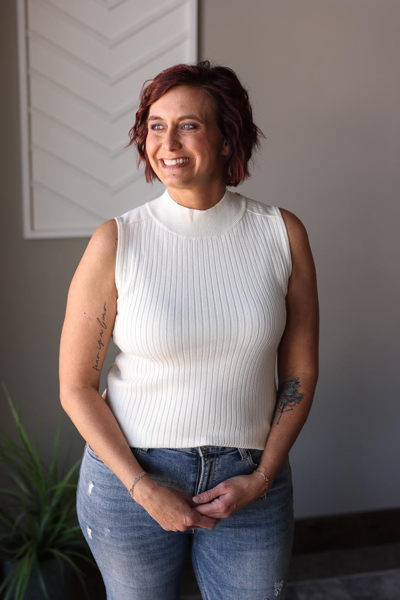 Stay stylish all year round with our White Ribbed Mockneck Sleeveless Sweater! Made from a lightweight, soft sweater material, this versatile piece features a slight mock neck and chic shoulder accents. Keep cool in the summer or layer up for colder days. A must-have classic in your wardrobe! Classy Closet online women's boutique clothing for affordable womens tops and hard to find modest denim skirts. hull iowa