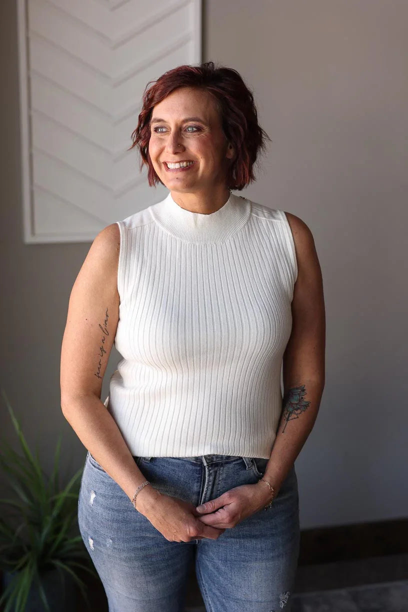 Stay stylish all year round with our White Ribbed Mockneck Sleeveless Sweater! Made from a lightweight, soft sweater material, this versatile piece features a slight mock neck and chic shoulder accents. Keep cool in the summer or layer up for colder days. A must-have classic in your wardrobe! Classy Closet online women's boutique clothing for affordable womens tops and hard to find modest denim skirts. hull iowa