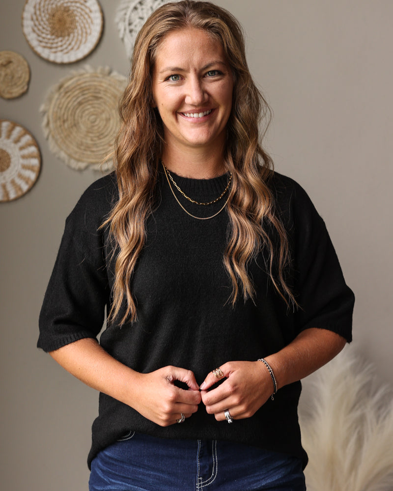 black half sleeve crew sweater with dark wash blue jean denim skirt