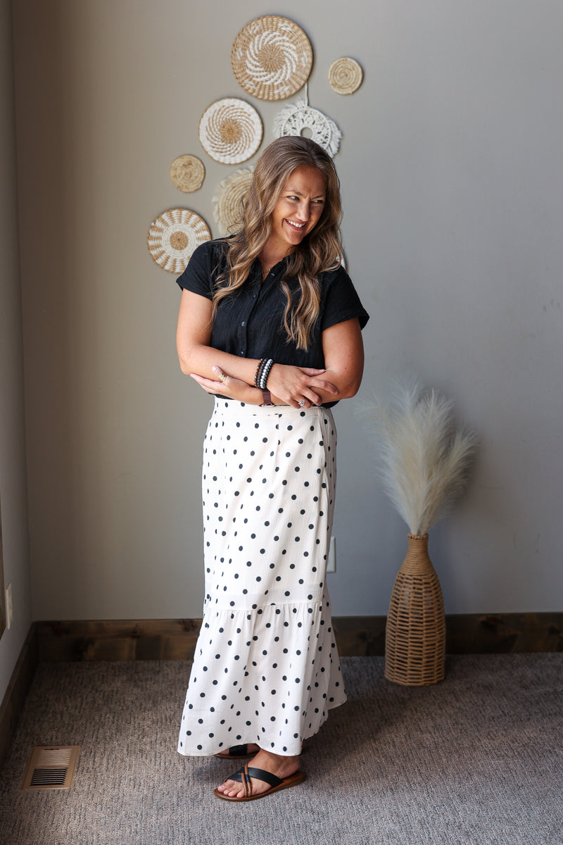 off white black polka dot maxi skirt with side slits paired with a black button up gauze top