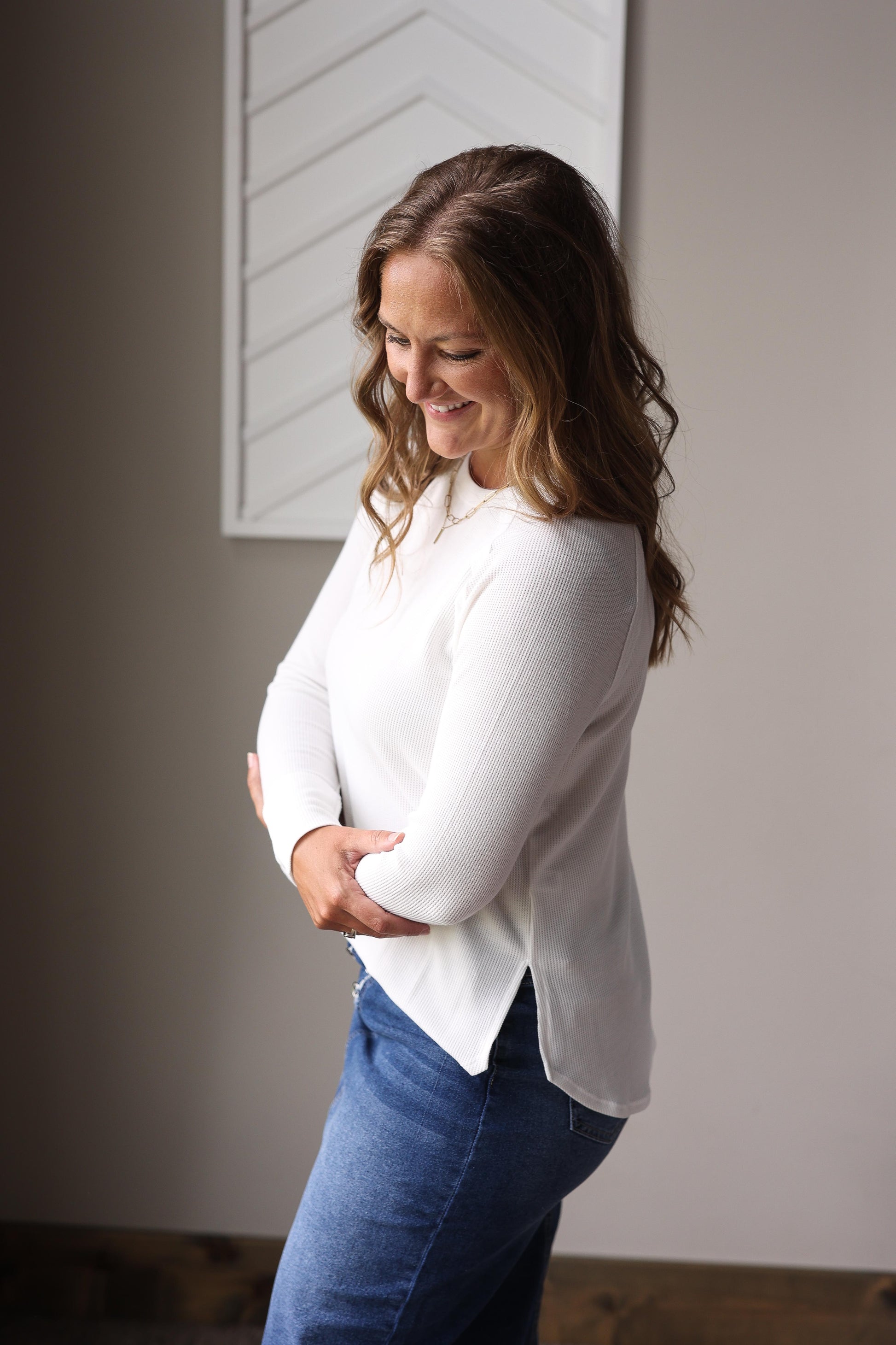 White waffle knit crew long sleeve top layered under denim jacket with plaid midi skirt.