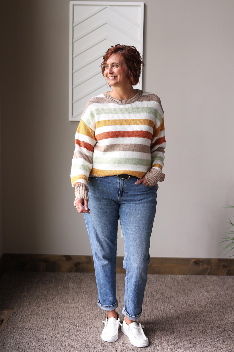 Celebrate cozy fall vibes with this Multicolor Stripe Crewneck Sweater, featuring soft fabric and a cheerful mix of autumn colors perfect for any casual occasion.
