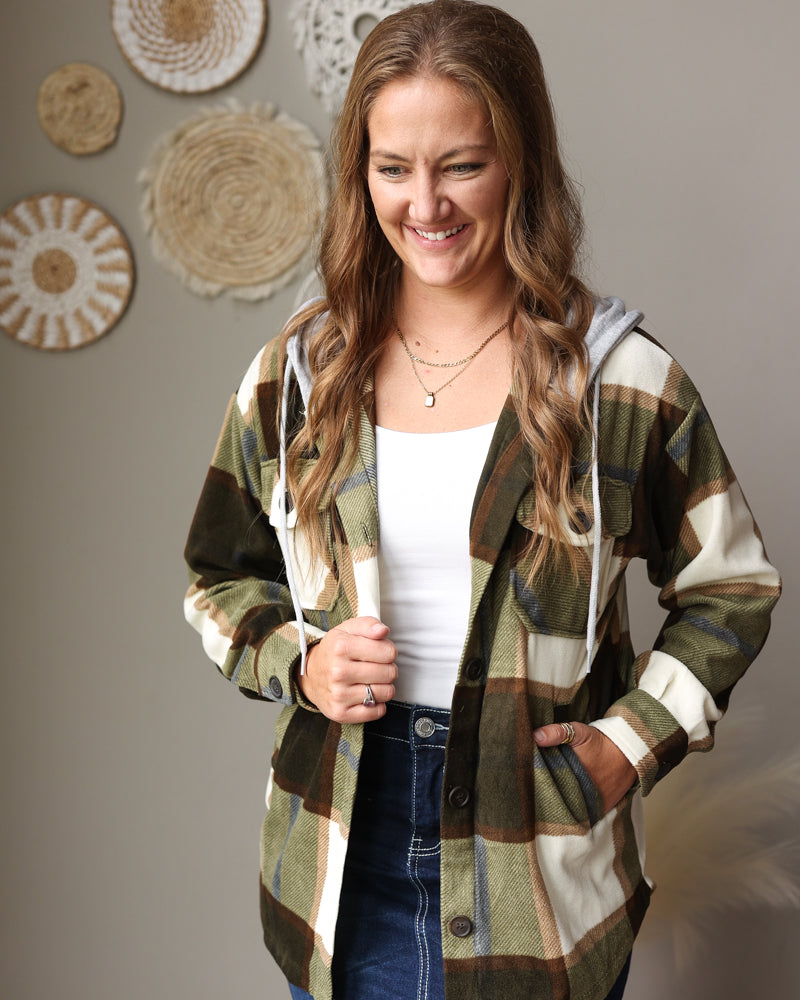 green white brown toned fleece button up shacket with a hood and side pockets styled over a white top with a dark wash midi denim skirt
