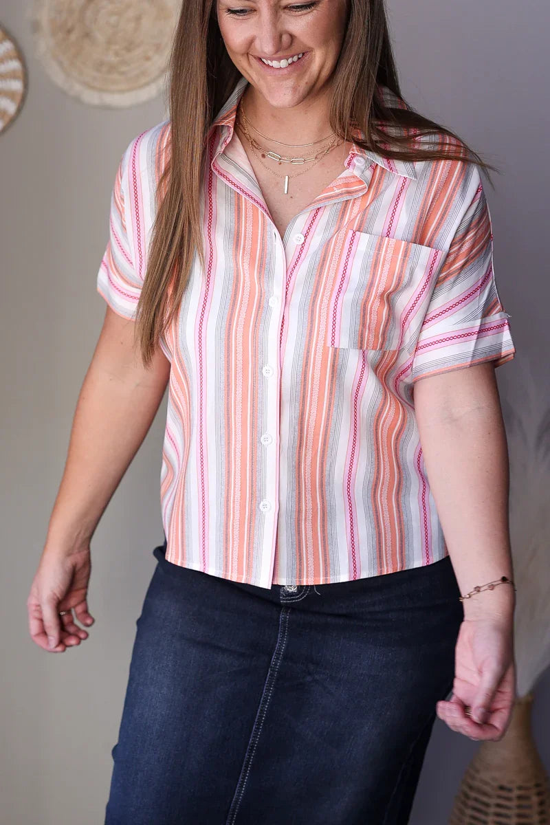 Woman wearing a striped shirt with a neutral background