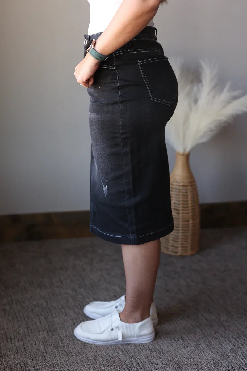 black wash denim skirt on a woman