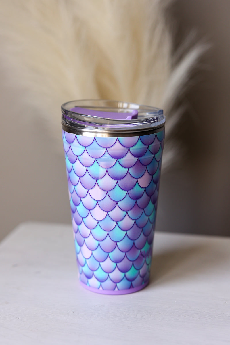 Tumbler with mermaid scale pattern on a white surface