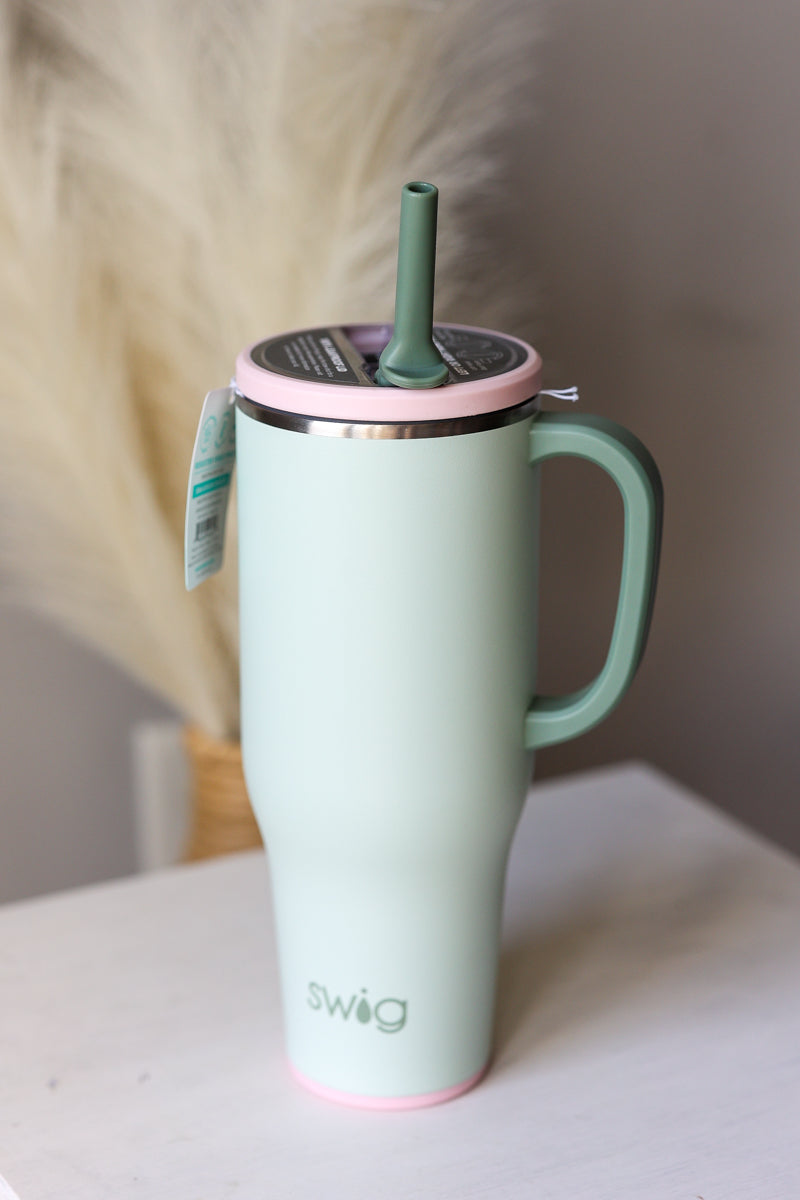 Mint green mug with pink lid and handle on a white surface SWIG Sage Mist 40oz mega mug with handle for teachers