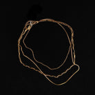 Gold chain necklace on a black background