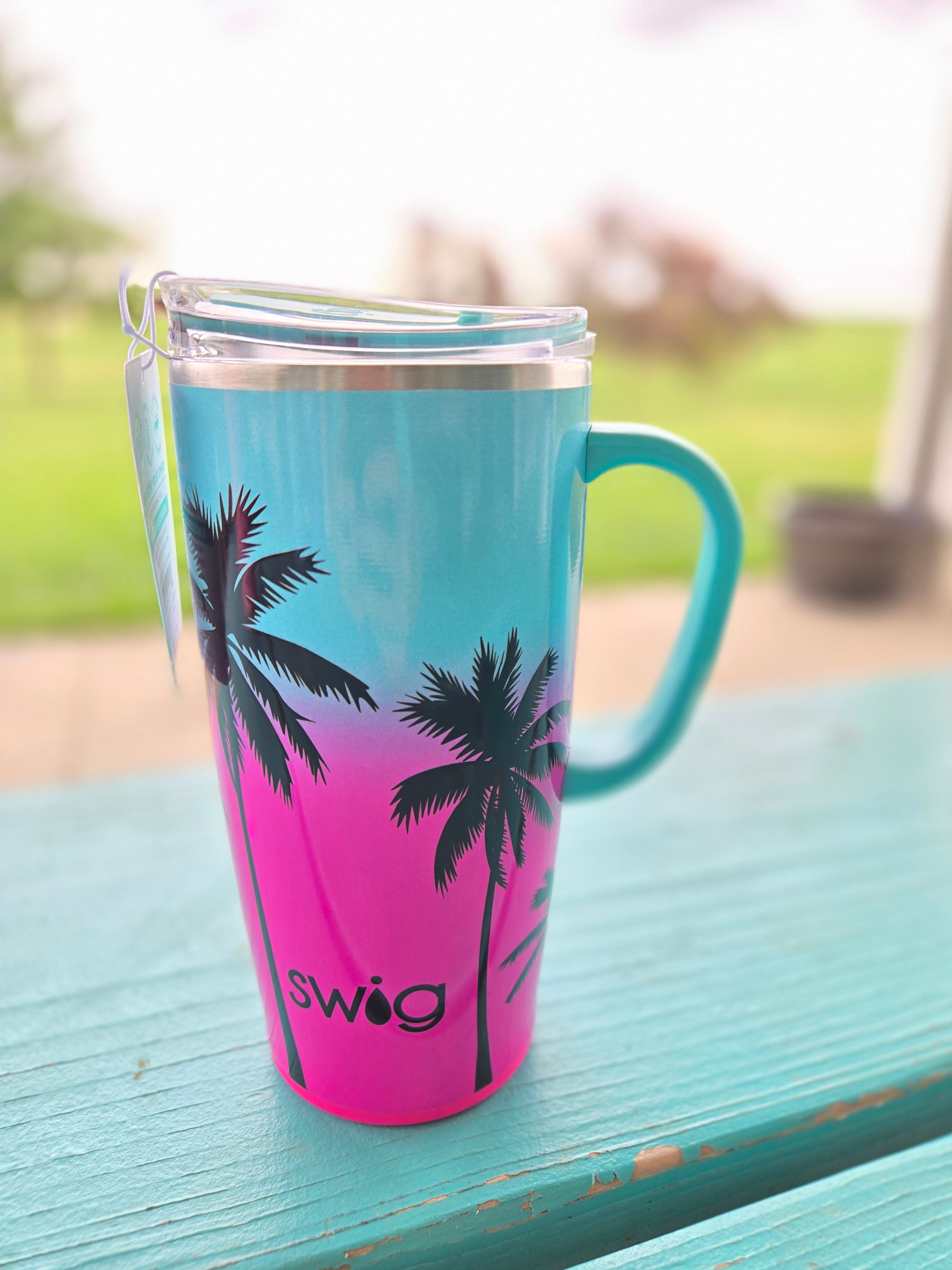 Gradient mug with SWIG palm tree design on a blurred background