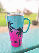 Gradient mug with SWIG palm tree design on a blurred background