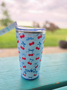SWIG party cup with cherry pattern on a wooden surface