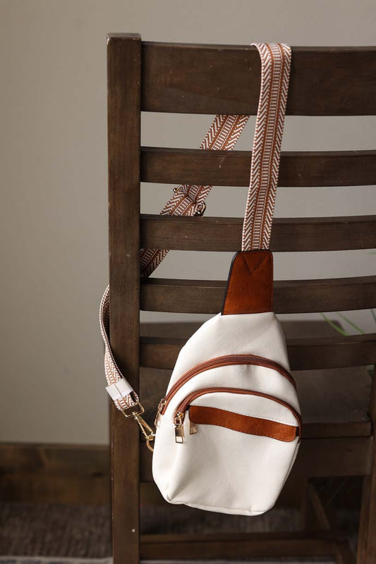 This White Multi Zippered Sling Bag is both stylish and functional with plenty of pockets to keep you organized. The classy white and chestnut contrast color scheme add a pop of color to any outfit. Stay organized and fashionable with this sleek crossbody bag. Classy Closet women's modest fashion online boutique Hull Iowa