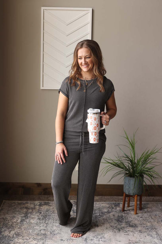 Our Grey Ribbed Top And Pants Set is the perfect combination of comfort and style. Made from our favorite corded material, this lounge set is ideal for everyday wear. The pants feature pockets, an elastic drawstring waistband and open legs for a comfortable and flattering fit, while the top's crewneck and short sleeves add a touch of style.  Classy Closet online women's boutique for modest fashion Hull Iowa