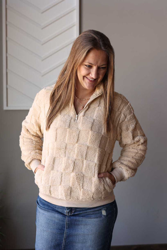 Stay warm and stylish this winter with our Beige Checkered Plush Quarter Zip Top. This cute and cozy top comes with pockets, perfect for keeping your essentials close while on-the-go. Don't sacrifice style for comfort, this must-have piece has got you covered! Classy Closet online women's clothing boutique for trendy, cute tops and modest fashion. Hull Iowa