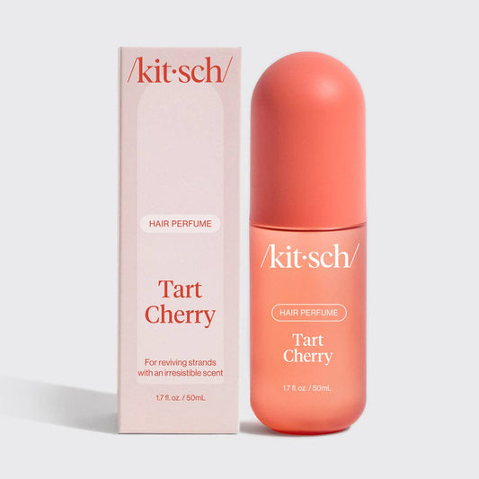Kit-sch Tart Cherry hair perfume bottle and packaging on a light gray background