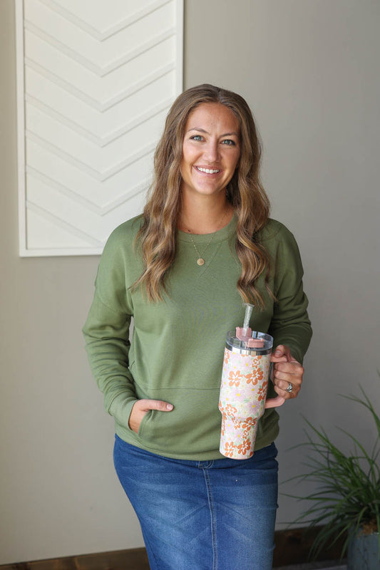 Stay cozy and comfortable in our Vineyard Green Pocketed Sweatshirt. Perfect for everyday mom life, this crewneck sweatshirt features a convenient front pocket and is ideal for layering during the winter season. Embrace simplicity and comfort with this must-have wardrobe staple. Classy Closet online women's boutique in the midwest for cute mom outfits and modest fashion.