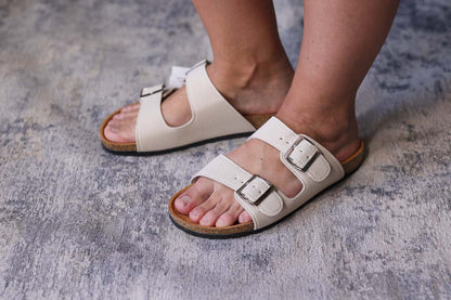 Meet your new go-to footwear friend! These Tan Double Buckle Slide Sandals are the effortless everyday option you've been searching for. Just slip them on and you're ready for anything! Their versatile tan color pairs perfectly with any outfit, while the double buckle detail adds a touch of style to your casual look. Comfy, cute, and completely fuss-free!