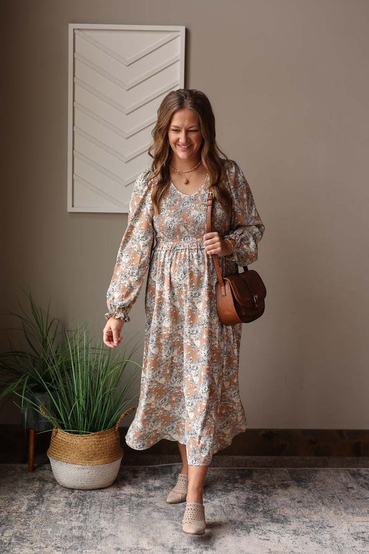 Stay effortlessly chic with our Khaki Floral Smocked Maxi Dress. Its soft fabric and smocked chest provide both comfort and style, while the elastic waistband and midi length flatter your figure. Perfect for weddings or church, its neutral tan color makes it a wardrobe staple all year round. BONUS: It has hidden side pockets too!! Classy CLoset online women's boutique clothing for modest fashion and feminine chic outfits in 2025. 