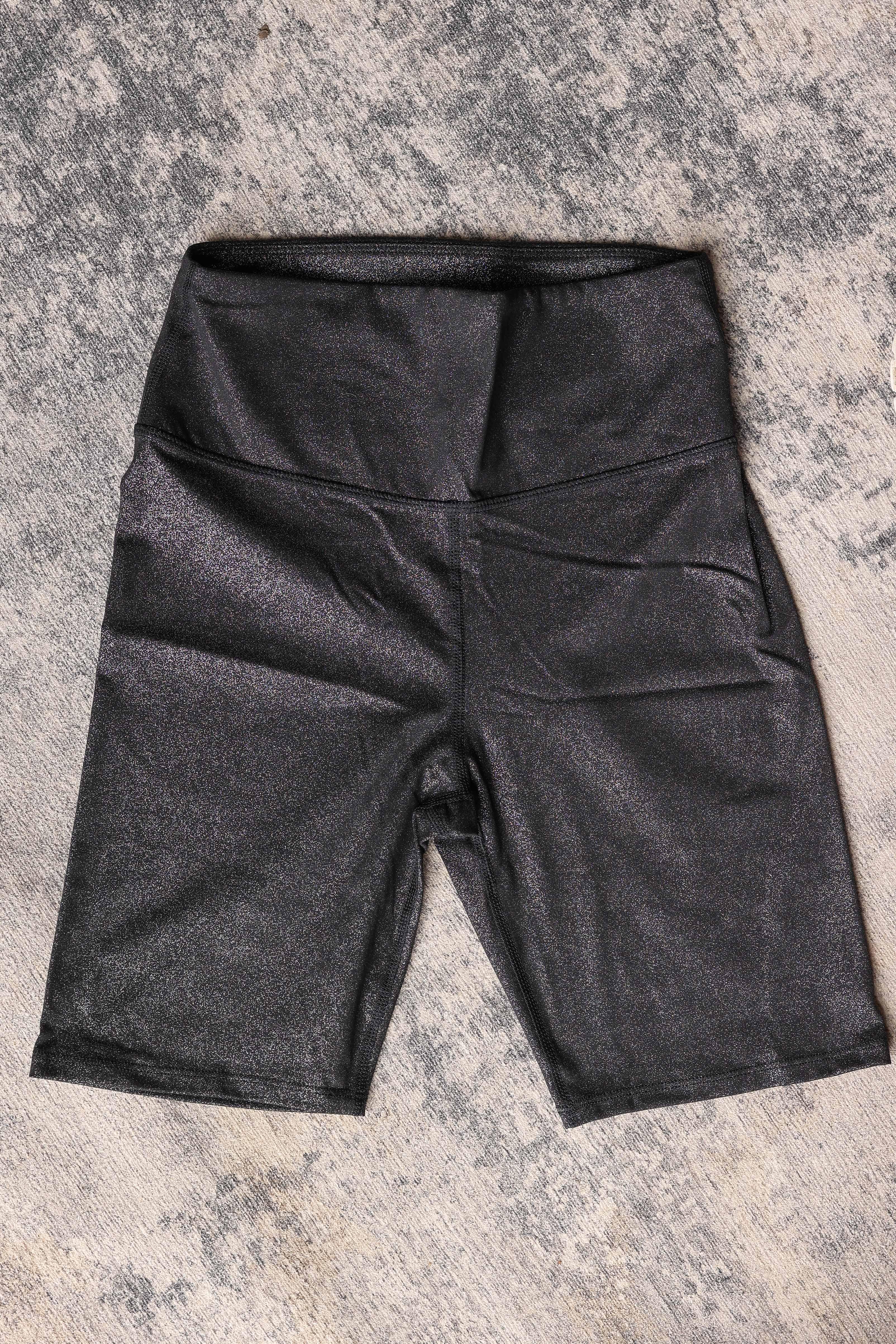 These high waist black biker shorts feature a subtle glitter print that adds a fun sparkle to your look. Designed with a snug, more controlling fit, they provide comfortable support while staying semi-slick to reduce cling under skirts and dresses.&nbsp;