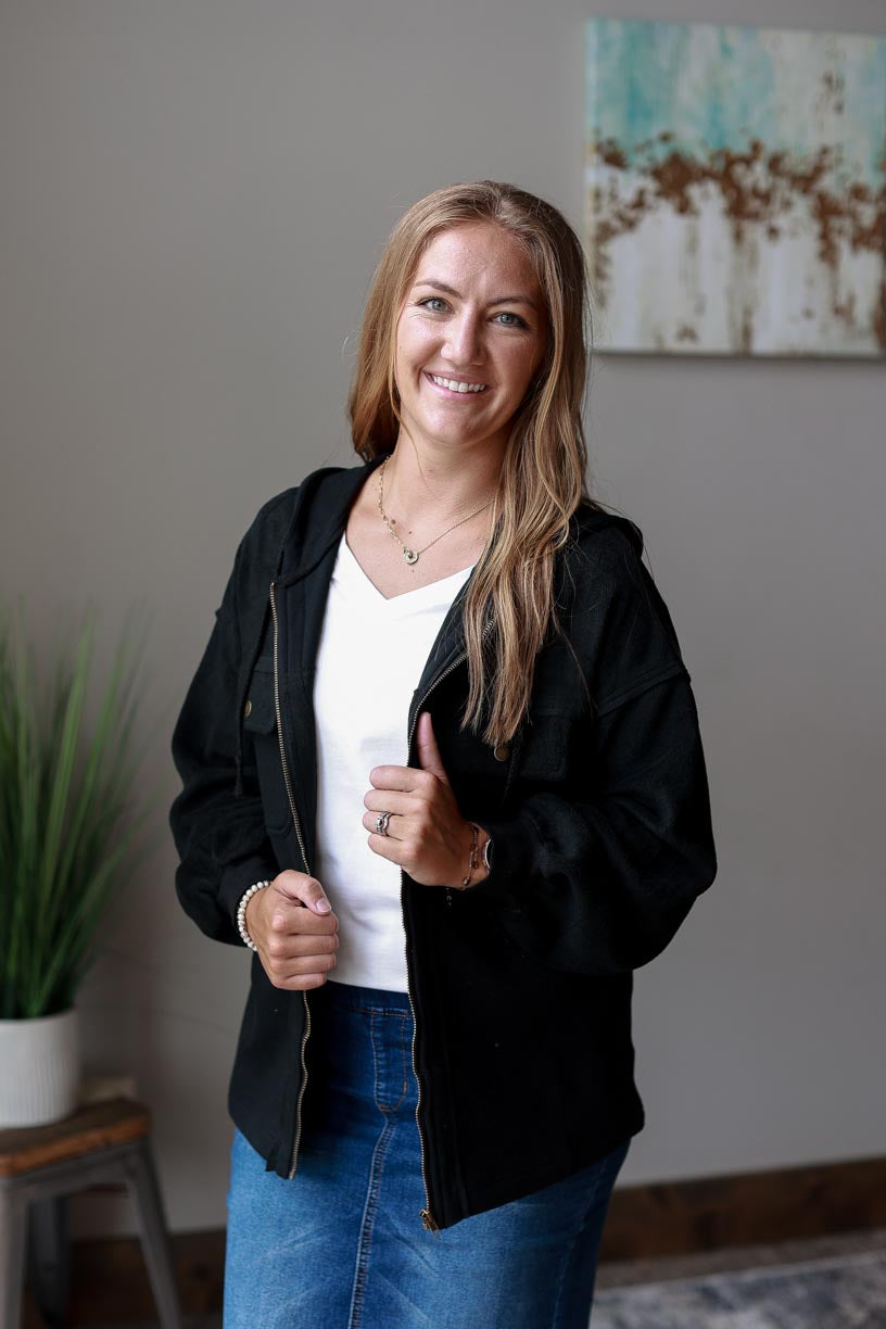 Black Hooded Zip Up Jacket. Made of black two-tone fabric with a drawstring hood, this jacket ensures maximum coziness and a timelessly trendy look. Beat the chill in style and keep cozy all season long! CLASSY CLOSET ONLINE WOMEN'S MODEST BOUTIQUE NEAR ME