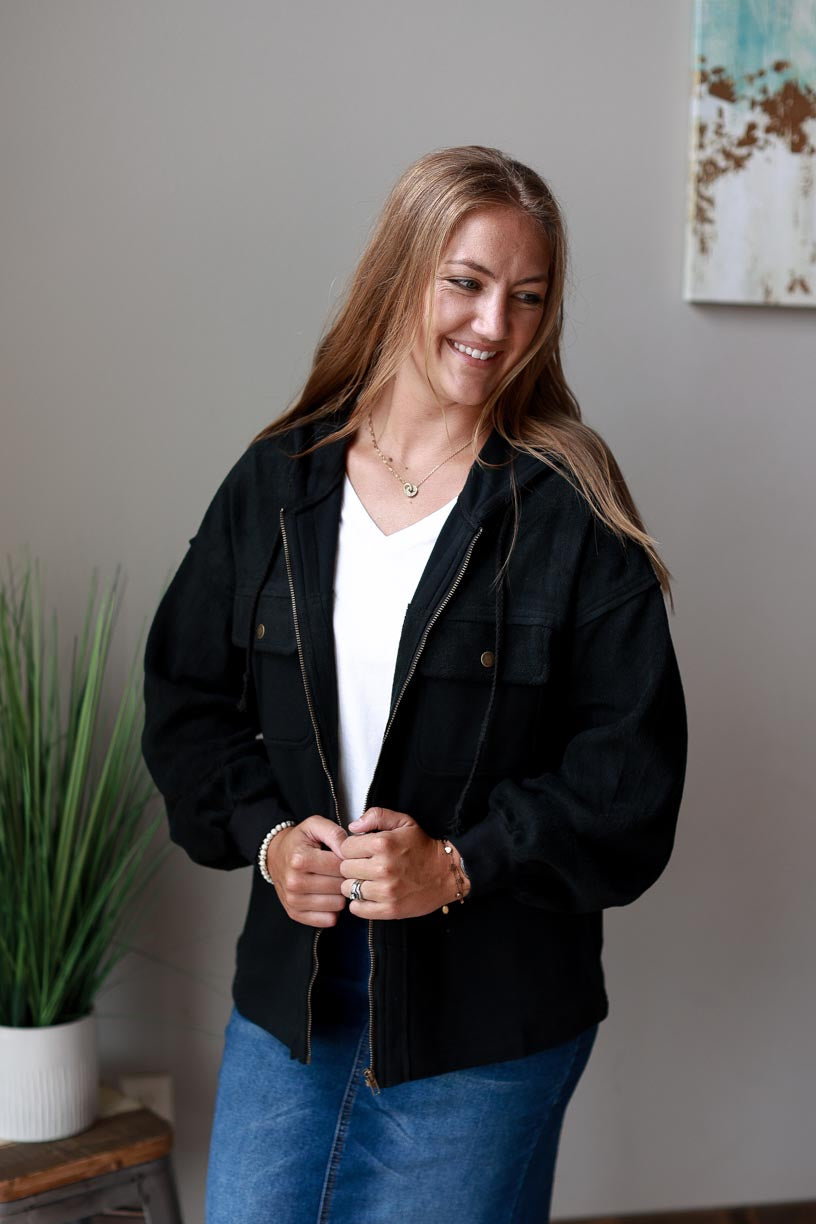 Black Hooded Zip Up Jacket. Made of black two-tone fabric with a drawstring hood, this jacket ensures maximum coziness and a timelessly trendy look. Beat the chill in style and keep cozy all season long! CLASSY CLOSET ONLINE WOMEN'S MODEST BOUTIQUE NEAR ME