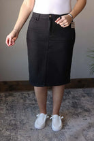 So excited to bring you our Stella Black Wash Knee Length Denim Skirt - the perfect addition to any wardrobe! Made with stretchy, solid black denim, this knee length skirt features a trendy back slit for a chic and comfortable fit. Add some color to your denim collection with this fun and stylish piece. Classy Closet online modest clothing for women, modest denim skirts, midi skirts, jean skirts, knee length skirts, Hull iowa