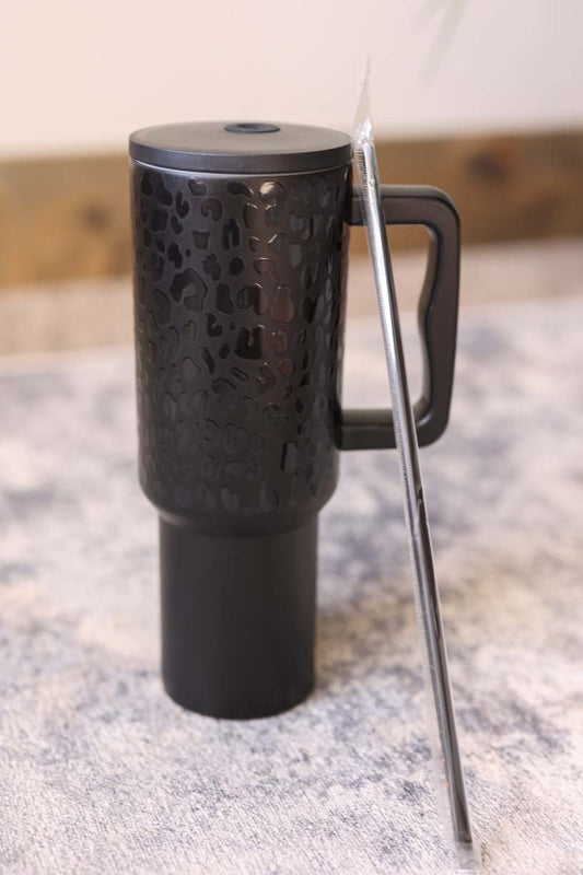 With a sleek and chic black leopard design, this 40 oz tumbler is the perfect combination of style and functionality. Keep your drinks at the perfect temperature on-the-go with its large 40 oz capacity. Stay hydrated and trendy with this polished tumbler.